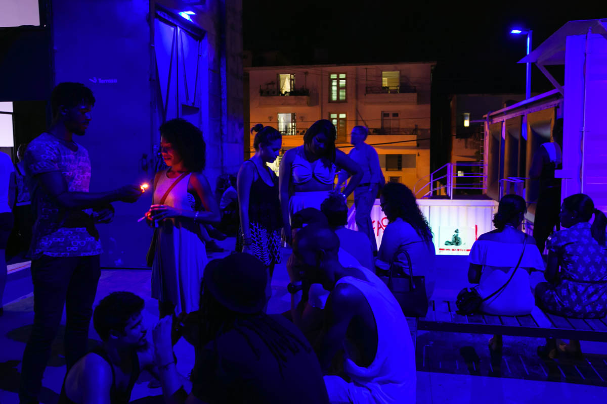 People hang out on the patio at the Fábrica de Arte Cubano, bathed in blue and purple light, in Vedado, Havana. The Fábrica — literally, Factory of Art — is a museum of contemporary art, event and performance space, nightclub, and all-around popular place for tourists and the young Cuban middle class.
