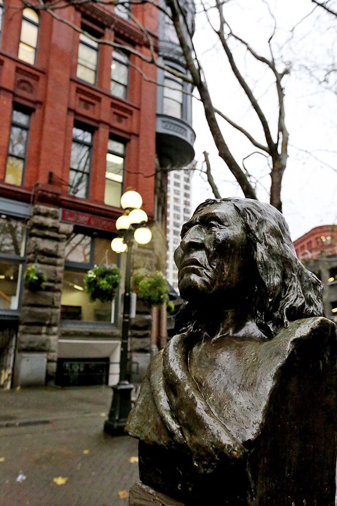 A bronze bust of Chief Seattle greets visitors to Seattle's Pioneer Square. Also nearby is a Tlingit totem pole and the popular iron pergola. (Greg Gilbert / The Seattle Times)