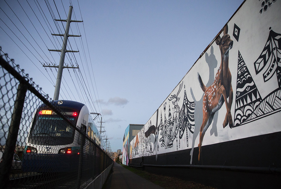 The SoDo Station serves Seattle's industrial area and includes warehouses, light manufacturing and a smattering of art galleries, antique stores, music venues and restaurants. Light-rail users will note the 32 murals that parallel the tracks. Here, a mural painted by Ola Volo, a Canadian illustrator from Kazakhstan, and Oregon-based artist David Rice. (Lindsey Wasson / The Seattle Times)
