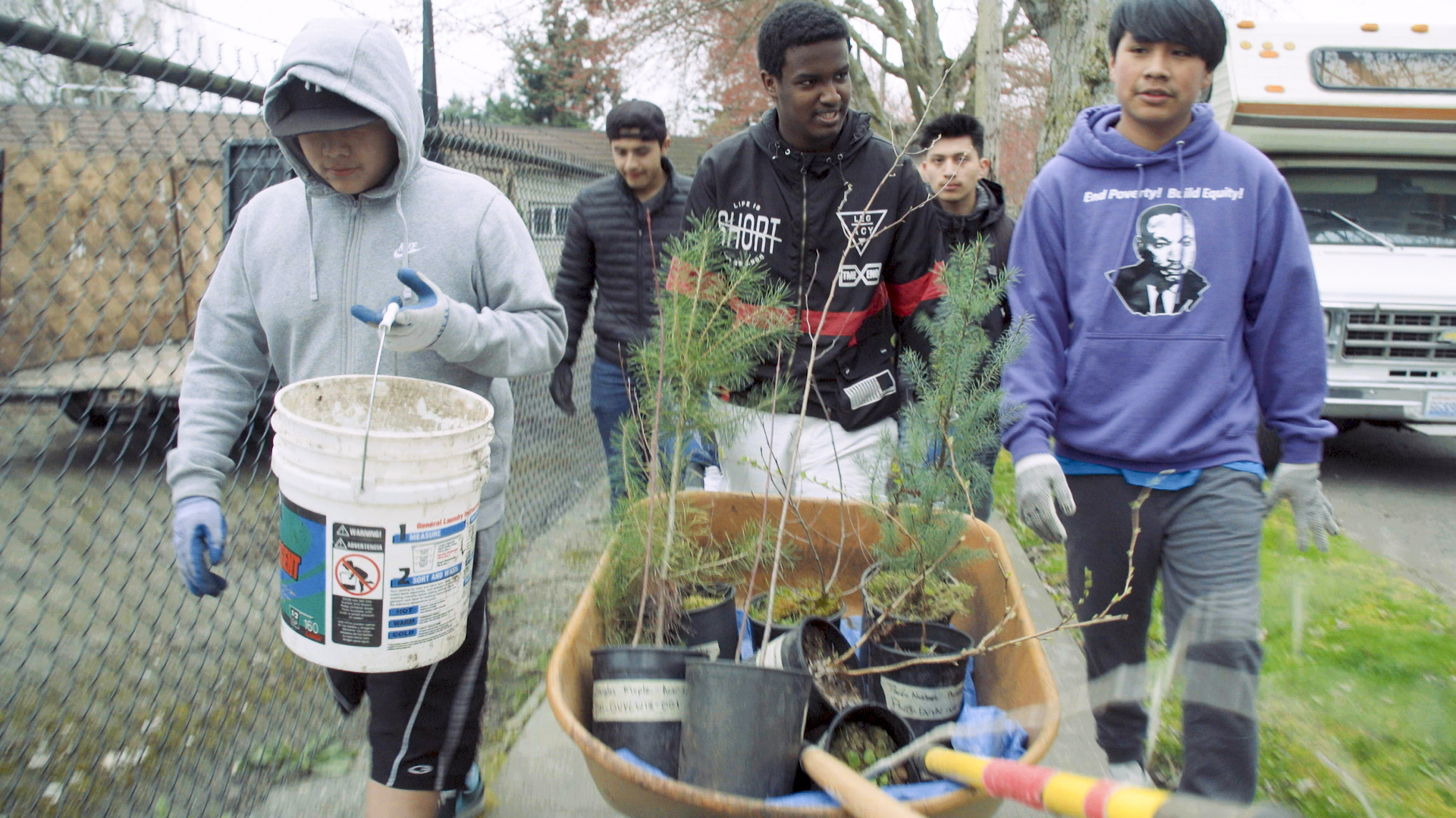 Teens with saplings and tools for planting
