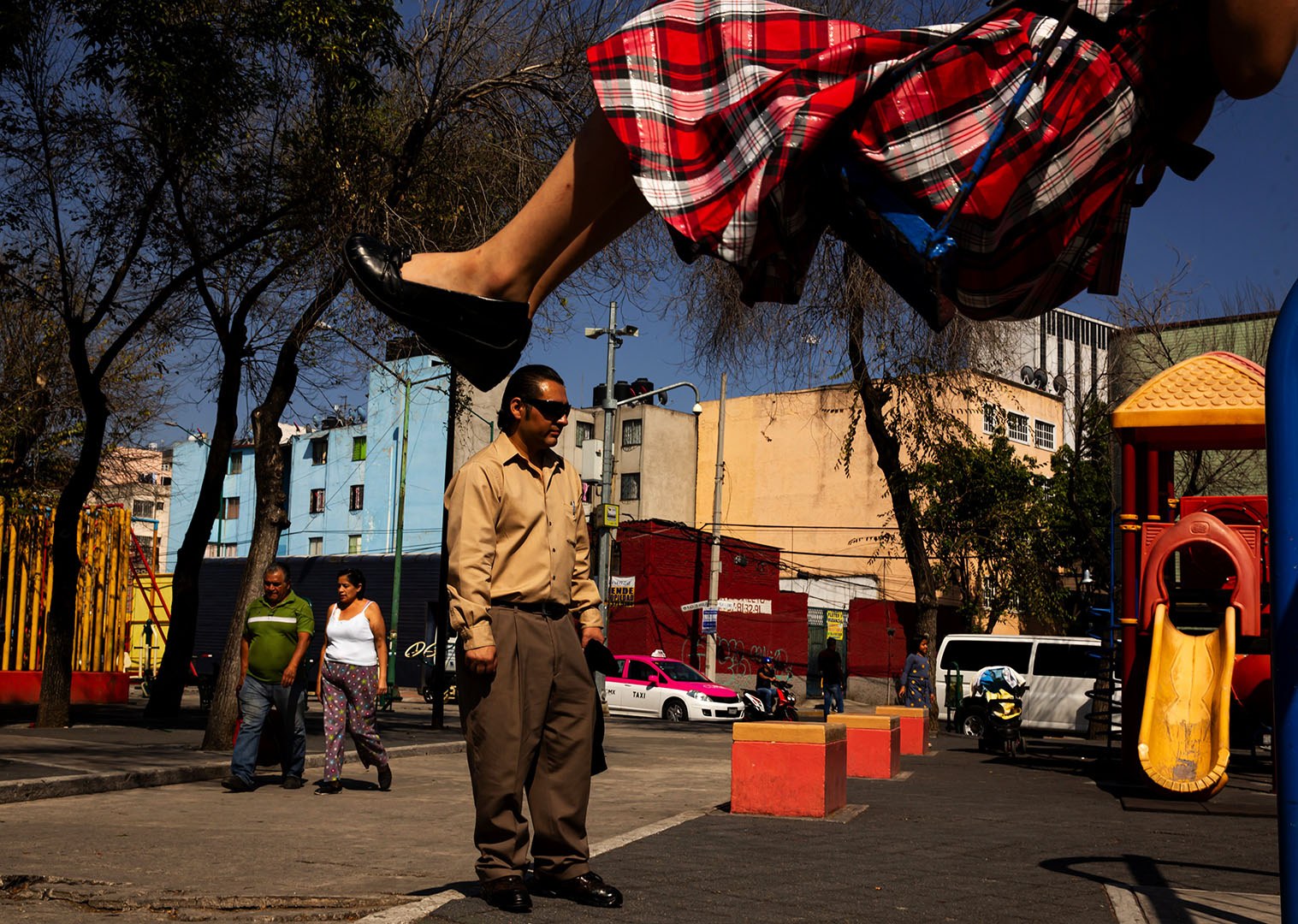 Josue Zarazua plays in the park with his three children in Mexico City.