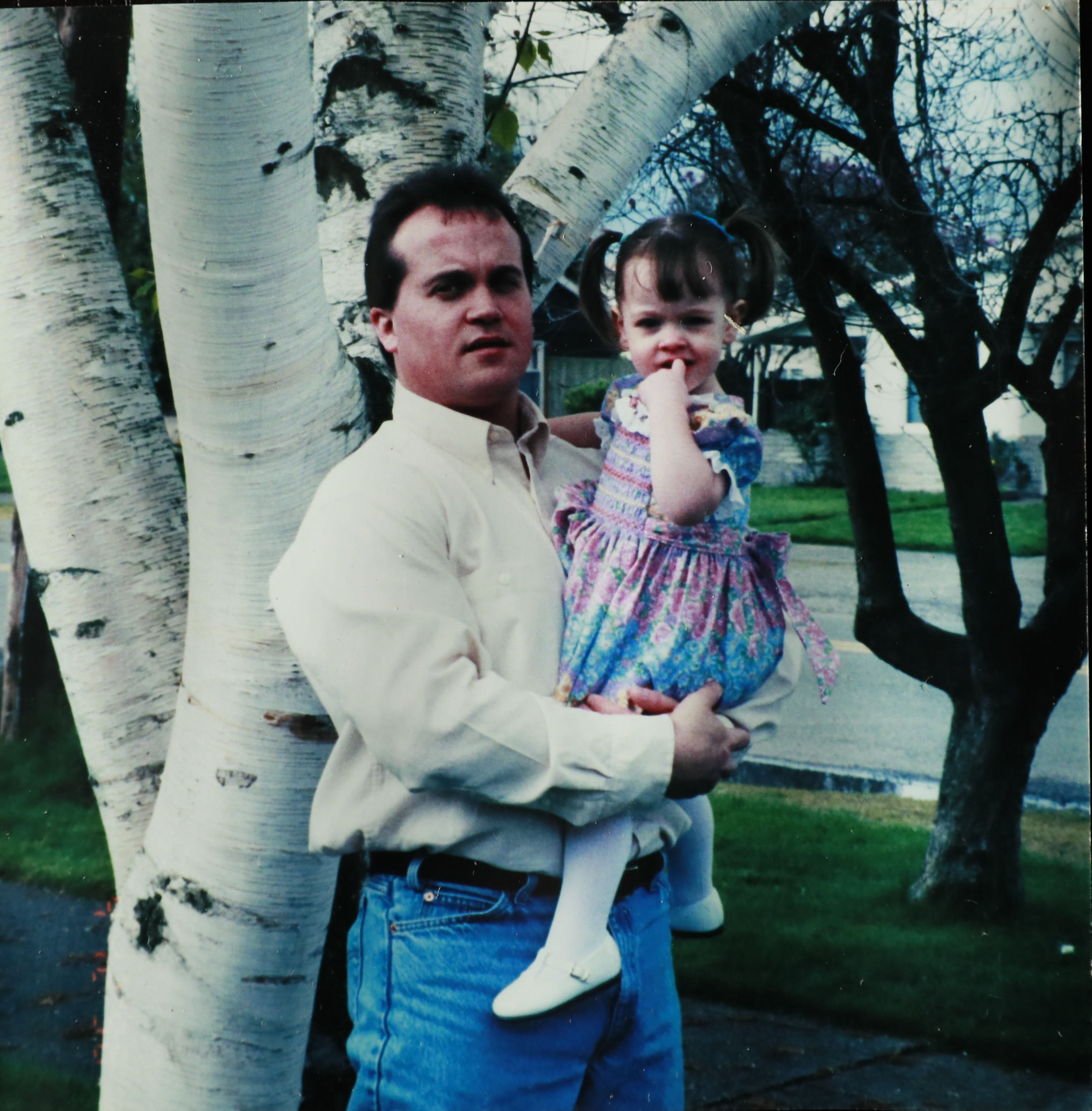 Eric Descalso holding young daughter