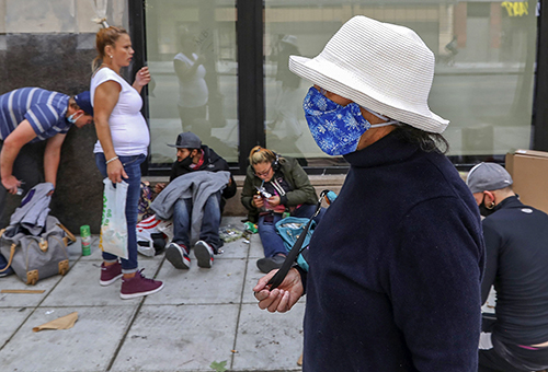 Downtown Seattle resident Cynthia Marin, 77, foreground, walks along Third Avenue. Marin was giving Seattle Times crime reporter Sara Jean Green and me a tour outside her apartment to show what it is like to navigate her neighborhood around daily drug use and street crime during the pandemic. Marin said she avoids this stretch when alone. My job is to show what reporters write about well before they write it. In this case, the purpose of the photograph is to visually 