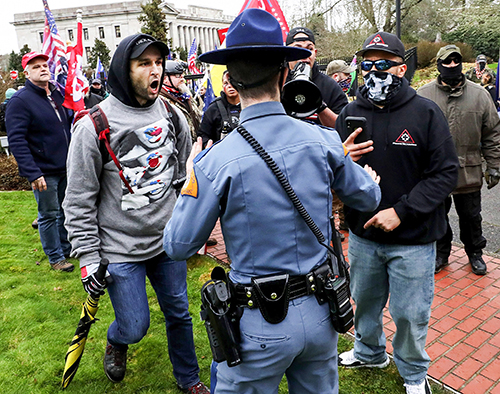 There was a sense that Jan. 6 could bring trouble to the state Capitol Building in Olympia. After the speakers, many armed, at the pro-Trump Stop the Steal rally, a few dozen protesters managed to breach the security fence to the governor’s mansion. One state trooper, backpedaling, attempted to stop them. Soon, more troopers and Thurston County deputies arrived outside the mansion. After 30 minutes, protesters were given warnings to leave or be arrested. Arguments took place among the protesters: All stick together, or all leave together. But some began leaving. The confrontation collapsed, and all left without any arrests. It could have gone in a different direction.