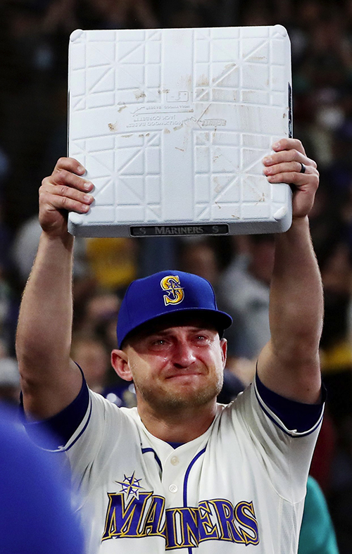 With tears in his eyes, Mariners third baseman Kyle Seager holds up the bag he was given from the hot corner he defended during a decade in Seattle. I had expected everything to stop in the ninth inning of the season’s last game against the Angels to celebrate Seager. I didn’t expect head groundskeeper Tim Wilson to give Seager third base. Shortly before the gifting, while photographers rushed toward the dugout to cover Seager hugging teammates, I stayed put in the photo well, standing on a chair, unsure what was happening, and I monitored Seager’s unscripted movements from on high. When Seager suddenly darted back onto the field to receive the base, I was in pretty good position to get a clear view of a moment that lasted only seconds.