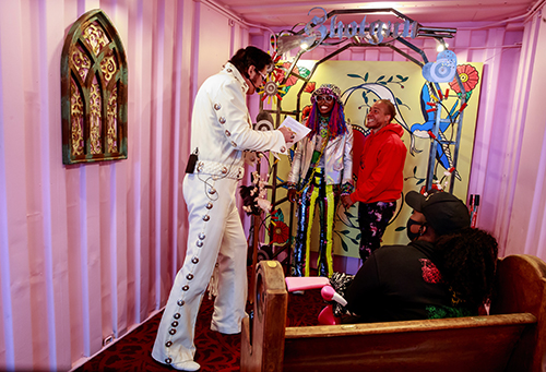 Andreya Taylor-Shorter and husband Royce Shorter Jr. renew their vows with Elvis impersonator Shane Cobane at Shotgun Ceremonies in Georgetown. The couple, who were married at the Elvis Chapel in Las Vegas, have a tradition of renewing wedding vows. “When we first got married, he told me he wanted to marry me every year,” says Taylor-Shorter. When the coronavirus pandemic closed down Washington state last spring, Bronwen Stevenson shuttered Shotgun Ceremonies, her Pioneer Square business of 10 years. In May 2020, Stevenson and her husband had transformed an old shipping container used for storage into a tiny Vegas-style wedding chapel. They painted it bubble-gum pink, decorated it with two tiny benches, and installed carpet and an arch. The floor-to-ceiling metal doors can be kept open to allow for airflow. “There’s a lot of people who like a traditional wedding, and there’s a lot of people who don’t,” says Stevenson. “Some people want it simple, fun and quick — and that is Shotgun Ceremonies.”