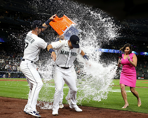 From left, Mitch Haniger gives Dylan Moore of the Mariners the first of three liquid baths, as Root Sports interviewer Jen Mueller tries to stay dry, after Seattle beat Houston on Moore’s grand slam. Seattle was down 8-7 with the bases loaded in the eighth when Moore, facing Brooks Raley, unleashed a rocket 395 feet to left field. I would categorize these somewhat-clichéd postgame splash celebrations as the 