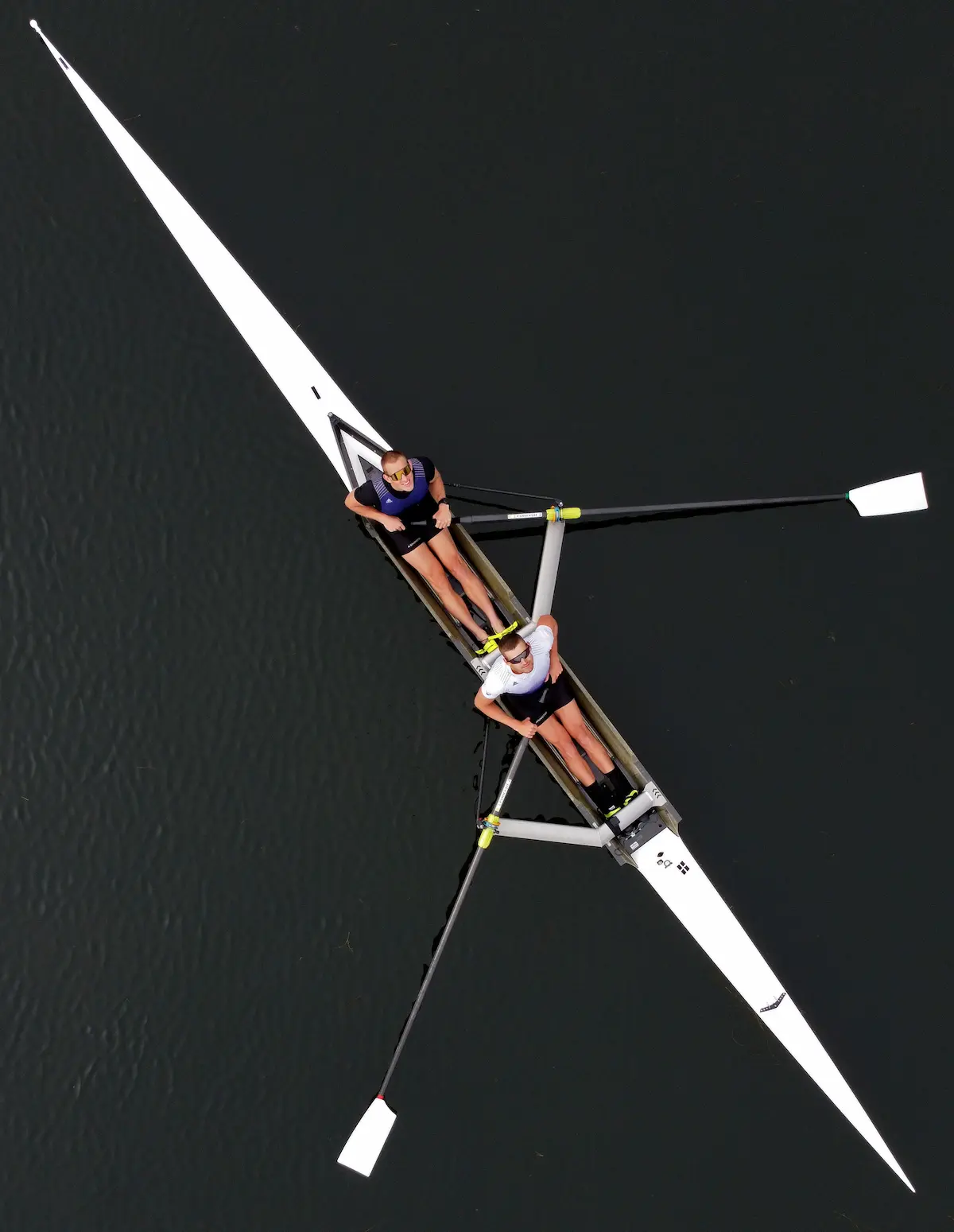 When the University of Washington men’s rowing captain, Steve Rosts, top, and Chase Barrows agreed to a drone portrait after their practice in May, they probably did not expect it would be so involved. I would not have guessed so myself. Seems easy: I am equipped with a two-way radio, enabling communication with them as I stood on the dock from afar looking down into my cellphone and trying to figure out a pleasing composition. No background to worry about. Everything is in focus. But almost immediately, both athletes had to return to the dock to pick up sunglasses, because looking up at a drone and squinting was just not going to fly.