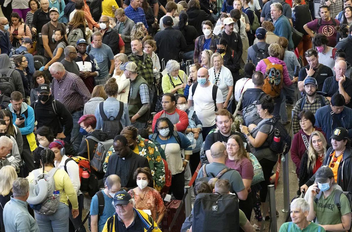 Passengers were delayed in long security lines at Sea-Tac International Airport, with lines leading out to the parking garage for a brief time on this morning. Wait times were up to 90 minutes the day before, though people reported waiting inline for up to two hours. Although most people think the Thanksgiving holiday produces the longest lines at Sea-Tac, it’s actually busiest during the summertime. Passengers didn’t seem too worried about previous COVID restrictions, which were lessened in September, when this photo was shot, but the long lines and waits definitely were back.