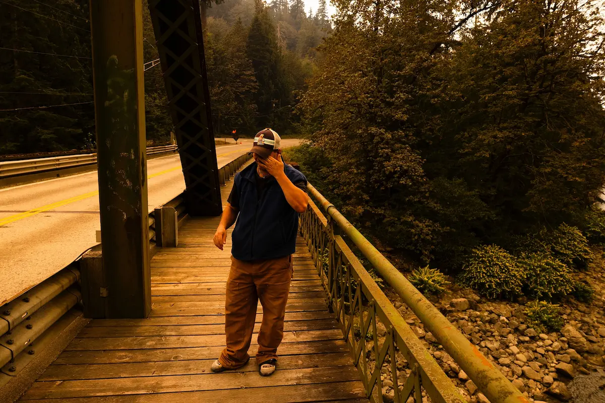 Matt Rodriguez coughs and rubs ash out of his eyes near Index as the Bolt Creek Fire burns. I met Rodriguez as I was going through the affected areas of the fire. I remember him driving a golf cart around, checking road closures, to make sure his father could get home later in the day. There was a moment when a piece of particulate from the fire fell into his eye, and as I photographed that, I realized that with the environmental orange tint combined with the moment, it would show how bad the air quality was.