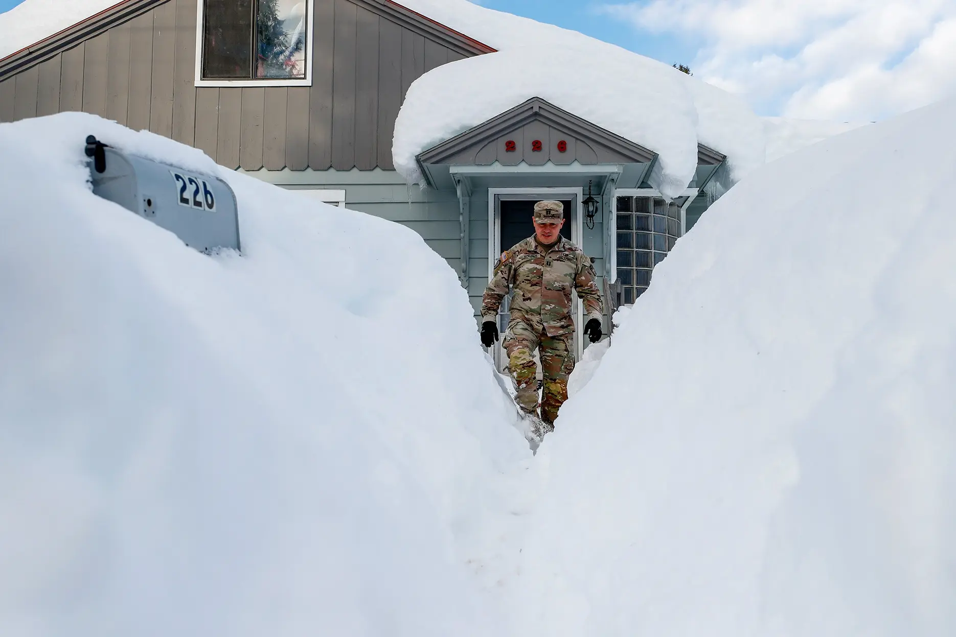 Washington National Guard Capt. Luis Torres carefully steps through a front yard snow gully after checking in on a Leavenworth home. After 4 feet of snow fell on the Bavarian-themed town, the National Guard was dispatched to check on residents and assist the town with digging out from the massive snowfall. As soon as they were dispatched, so was The Seattle Times. Reporter David Gutman and I started early from Seattle, driving the long way over Interstate 90 and Blewett Pass because Highway 2 was still closed and would remain that way for another three days. A mostly snow-covered sign welcomed us to Leavenworth. Were the people OK? Did they have enough food? Enough firewood? Enter the National Guard. Hardy civil servants clad in tan camo drew up maps of the town and spread out to knock on every door to determine the condition of the folks inside. With that much snow, it’s not hard to make dramatic photos.