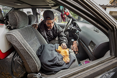 Andrea Longino, 34, and her dog Justice have been living in her car. (Ellen M. Banner / The Seattle Times)