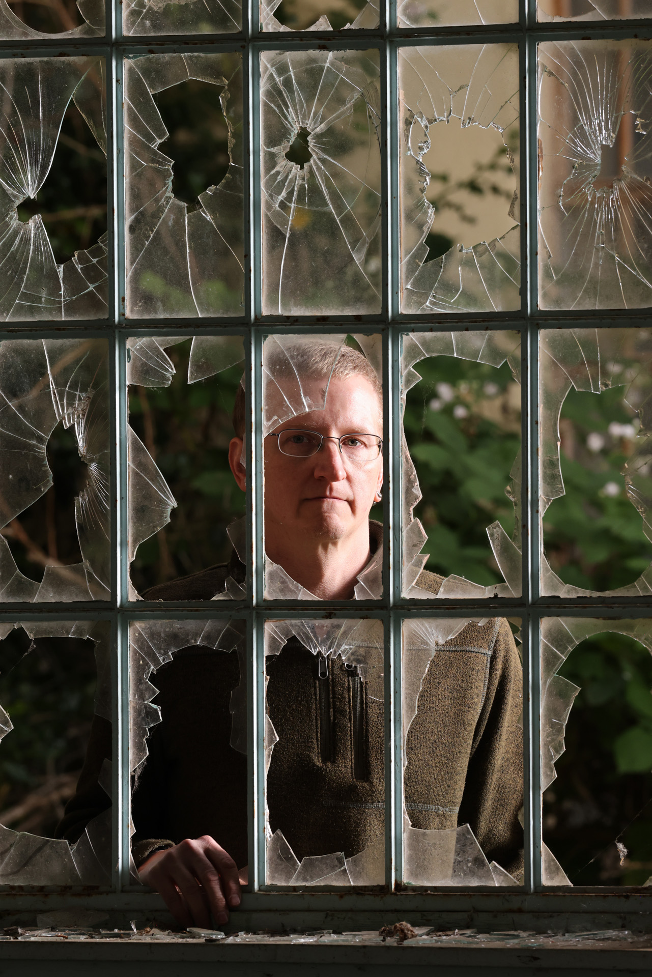 <p>Horne looks through the windows of the Gray building, also known as Ward 5, in Sedro-Woolley. Horne is a board member of the Sedro-Woolley Museum who researches Northern State Hospital’s history and burials. He hopes the buildings can be preserved. (Karen Ducey / The Seattle Times)</p>

