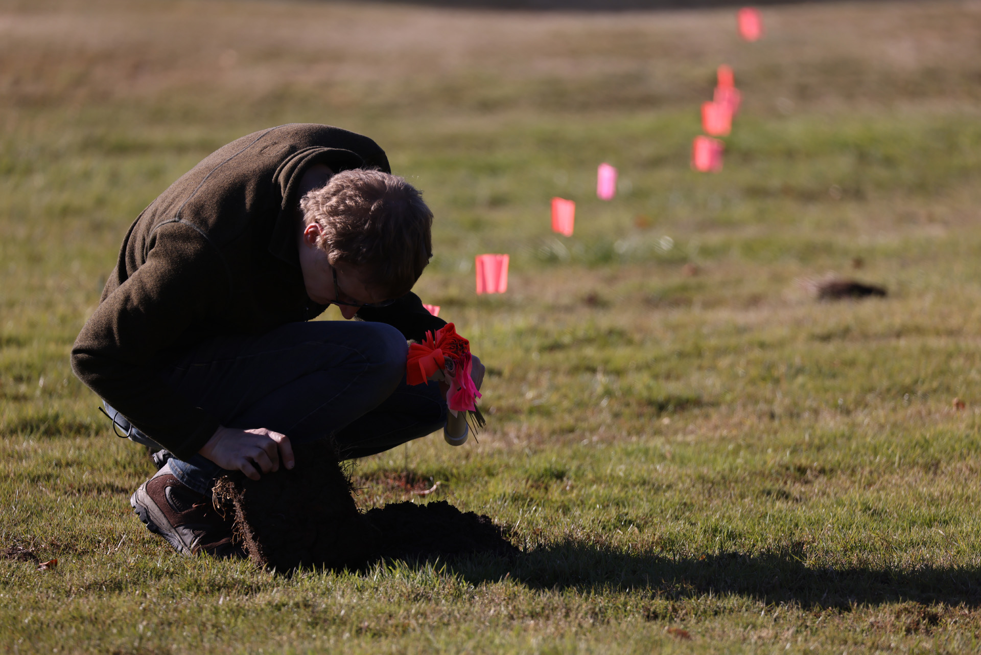 <p>Horne searches for grave markers at the Northern State Hospital cemetery. (Karen Ducey / The Seattle Times, 2022)</p>
