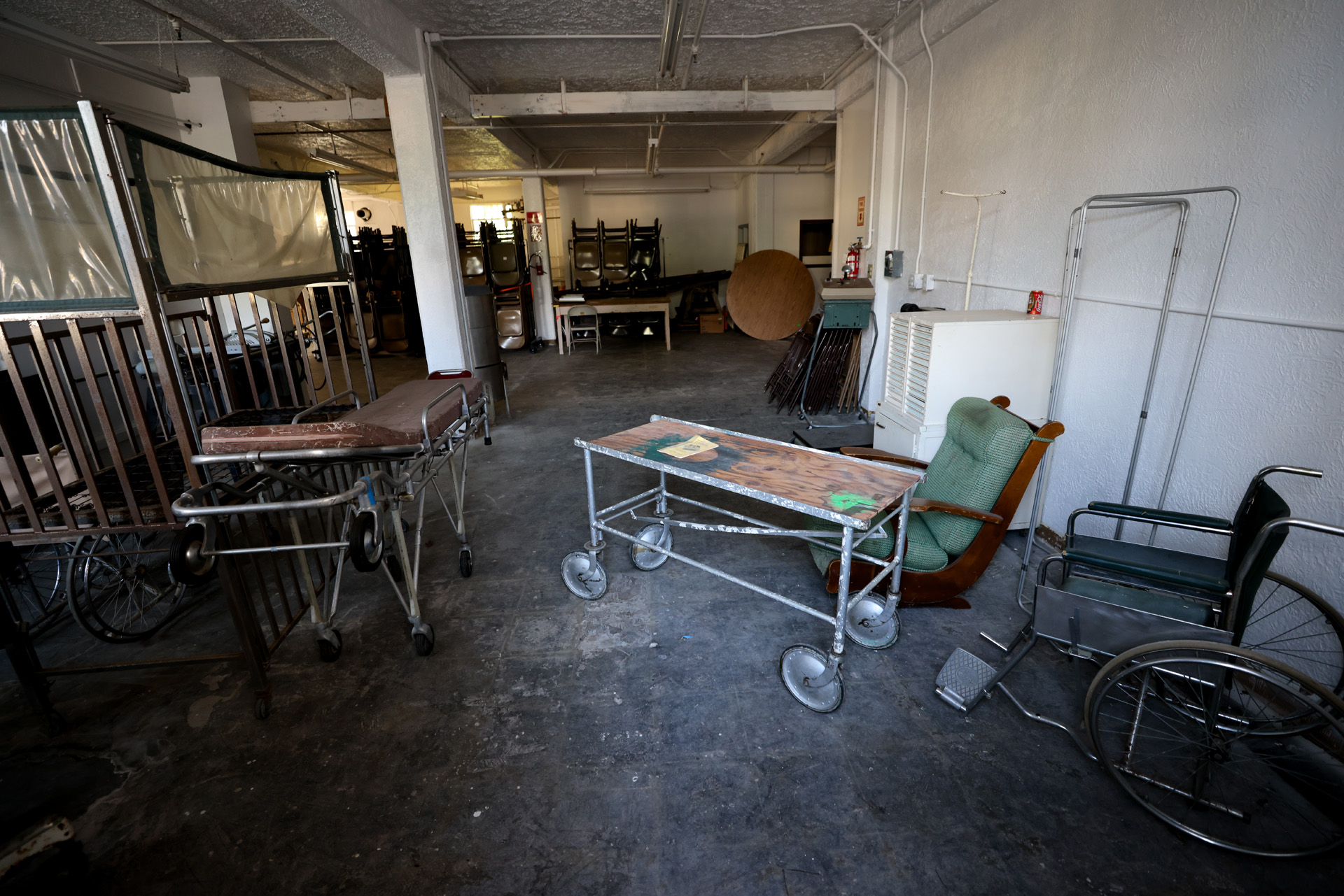 <p>What appears to be a gurney, stretcher and crib sit in the basement of Northern State Hospital. (Karen Ducey / The Seattle Times)</p>
