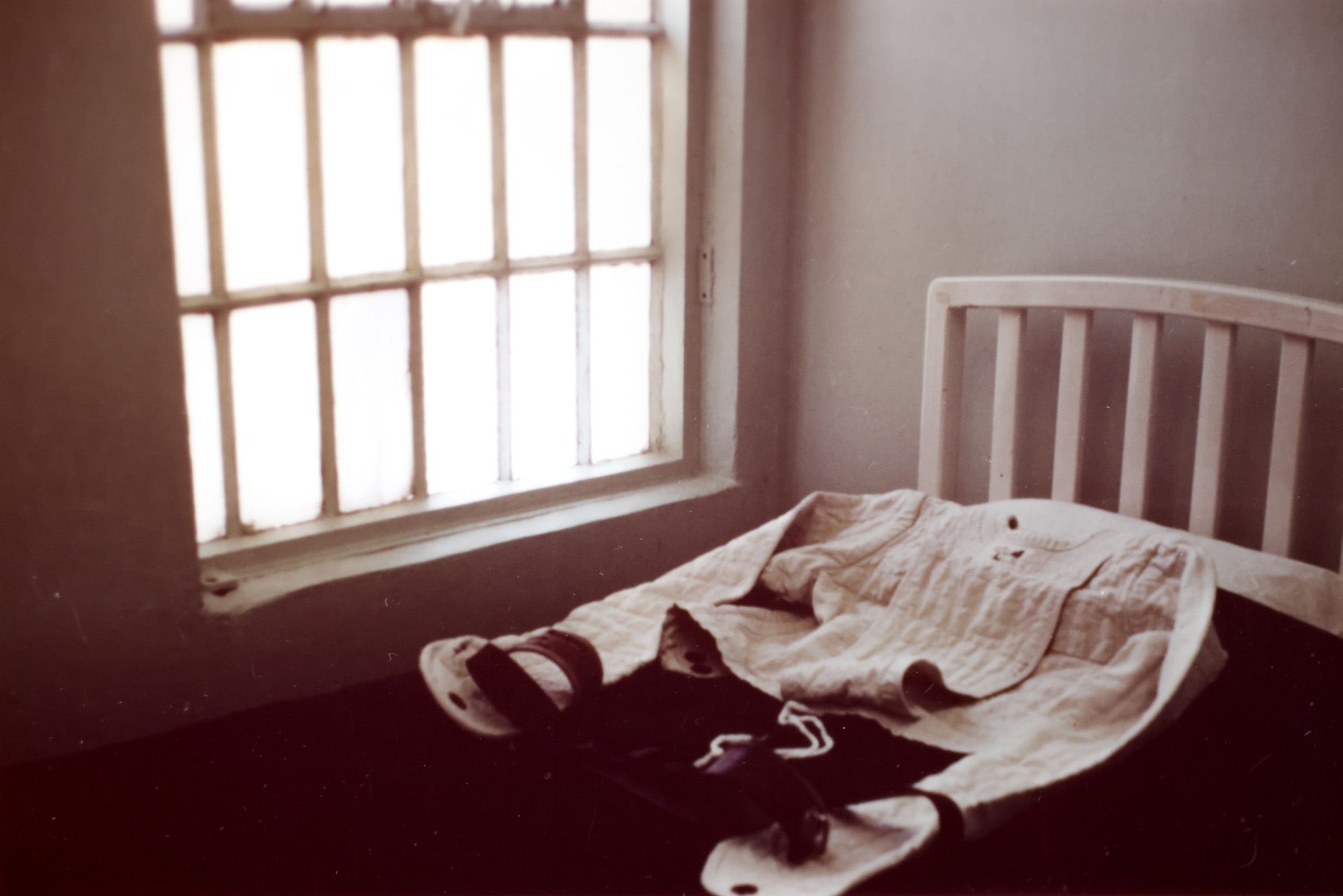 <p>A photo of what appears to be a straitjacket lying on a bed by a window. The image was found in the files of Northern State Hospital at the Washington State Archives in Olympia. (Washington State Archives)</p>

