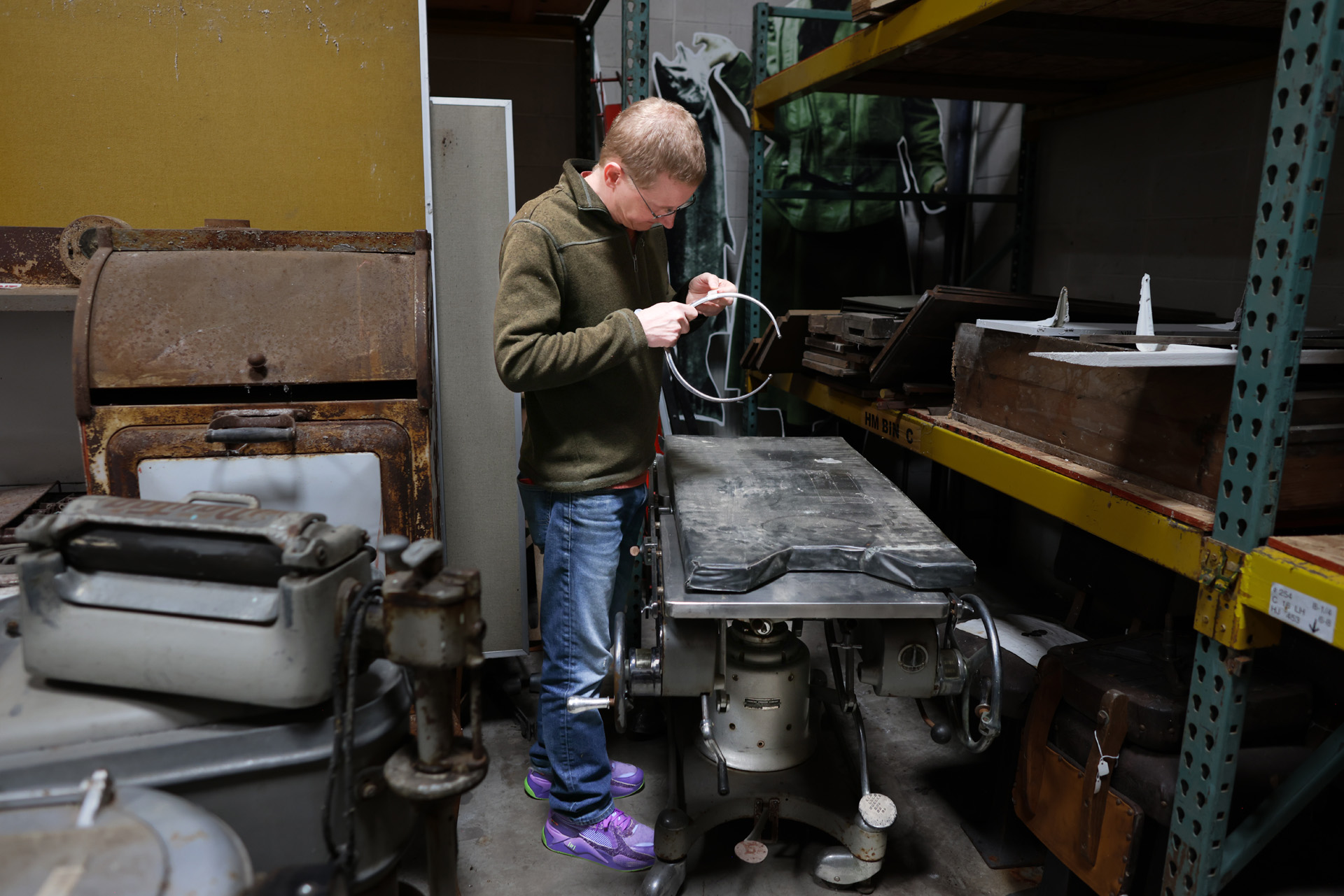 <p>Horne examines calipers found on an old operating table in the warehouse of the Sedro-Woolley Museum. (Karen Ducey / The Seattle Times)</p>
